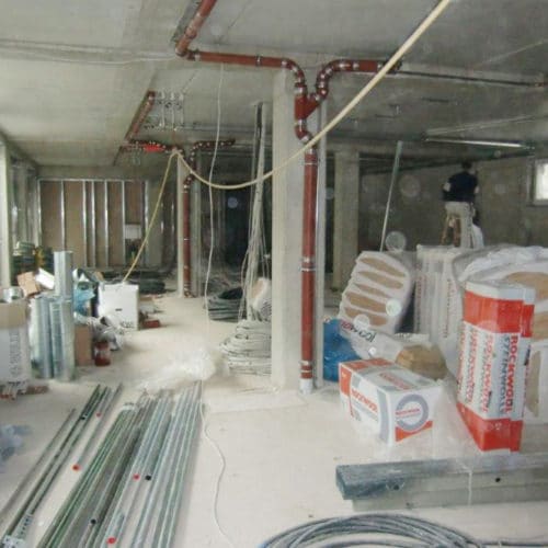 Innenansicht der Herz-Apotheke am Siegbogen während der Renovierung mit Baumaterialien und Handwerkern.